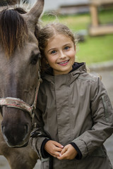 Young horse riding girl, equestrian sport . Horseback girl on field.