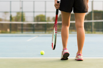 Tennis player holding racket preparing for playing game on outdoor court