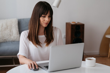 Female model at home office using her computer