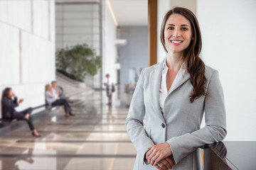 Head shot of a working smiling successful corporate executive beautiful brunette with career,...