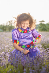 happy adorable caucasian little girl in fairy purple dress and magic stick