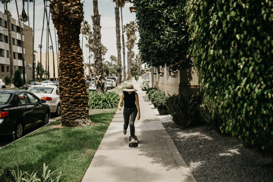 Woman riding skateboard toward camera
