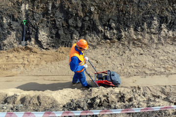 guest worker is building a trench sand stone earth