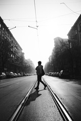 Person walking over tram lines - Black and White