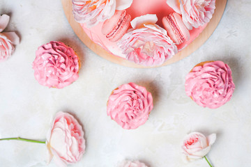 Pink cupcakes with roses and holiday cake.
