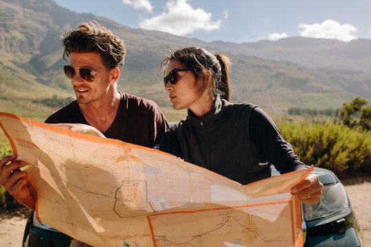 Young couple looking at map searching route