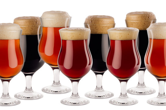 Decorative border of different beer in goblet with foam - lager, red ale, porter -  isolated on white background, copy space.