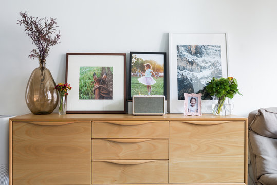 Sideboard with photographs and vase in living room