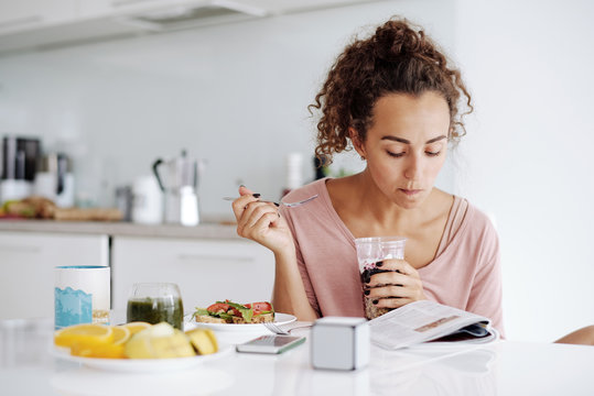 Woman reading at breakfast