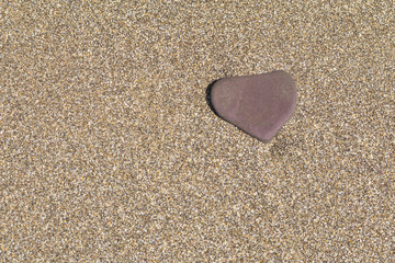 stone in the form of a heart in the sea, copy space