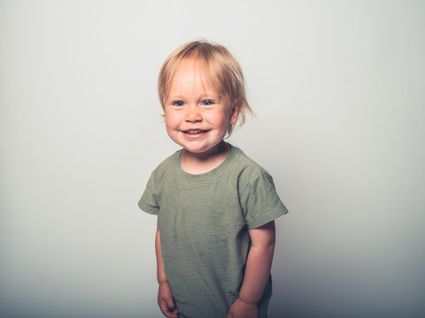 Cute little toddler boy posing on white background