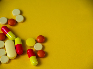 Tablets on a yellow background. Medicines.