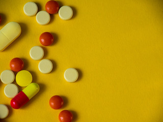 Tablets on a yellow background. Medicines.