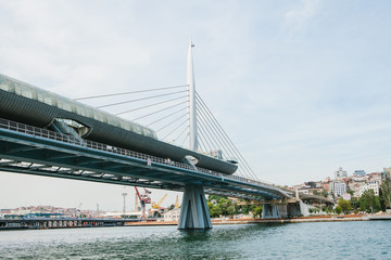 Part of the bridge in Istanbul connecting the Asian part with the European part of the city. The architecture of Istanbul is on the background