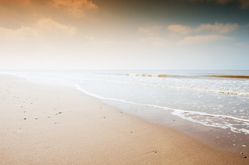 Fototapeta na wymiar Sandy beach at sunset. Beautiful nature background