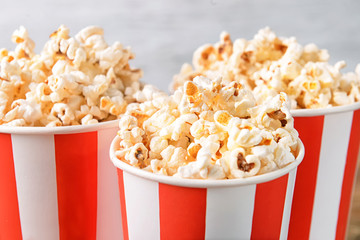 Cups with tasty popcorn, closeup