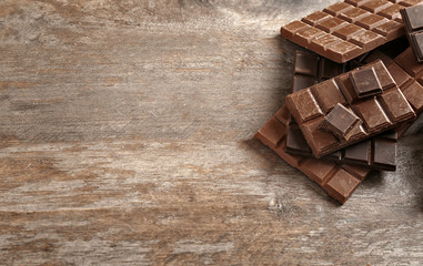 Dark and milk chocolate on wooden background