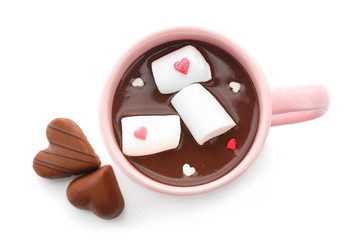 Cup of hot chocolate with marshmallow and candies on white background, top view