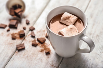 Cup of hot chocolate with marshmallow on wooden table