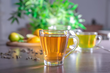 Glass cup with delicious tea on table
