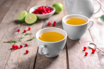 Tea set with hot beverage on wooden table
