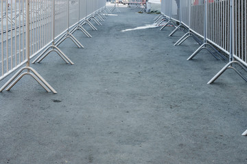 Portable metal grilles of light gray color for the obstruction of the territory and organization of...