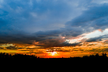 Storm clouds against a bright blue sky,sunset.