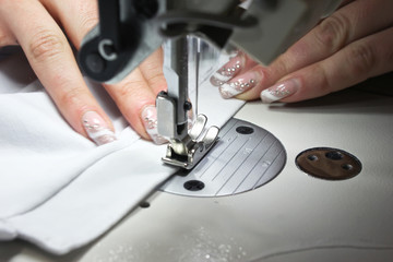 Sewing Process - Women's hands behind her sewing