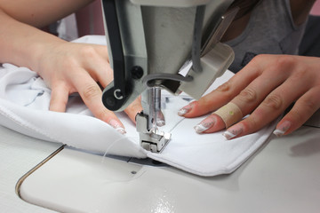 Sewing Process - Women's hands behind her sewing