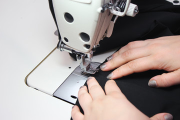 Sewing Process - Women's hands behind her sewing