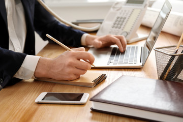 Businessman working at table in office, closeup