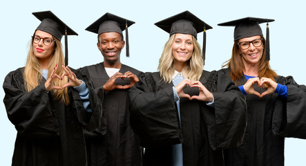 Education concept, university graduate woman and man group happy showing love with hands in heart shape expressing healthy and marriage symbol