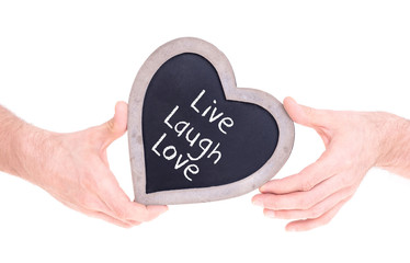 Adult holding heart shaped chalkboard - Live laugh love