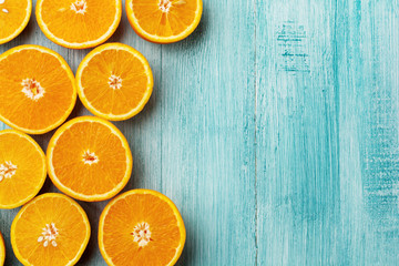 Orange slices flat lay on rustic blue wooden background. Top view.