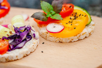 Open sandwiches of rice cakes with cream cheese , vegetables
