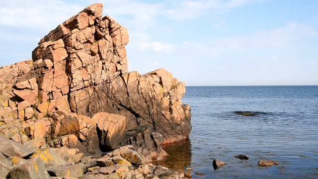 Steep cliff in calm sea at Hovs Hallar nature reserve in Sweden.