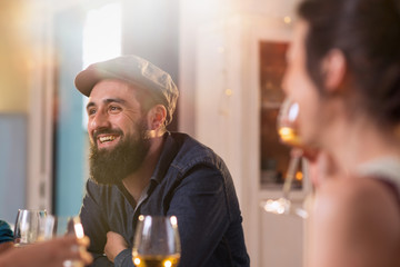 Mixed group of friends having fun while sharing a meal 