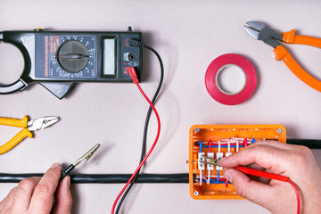 Electrical equipment. Tester in the hands of electrician.  Background and texture.