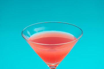 Red cocktail on blue background. refreshing cold drink and Summer vacation