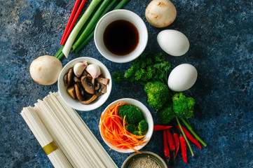 Ingredients of asian cuisine noodles eggs vegetables spices sauc