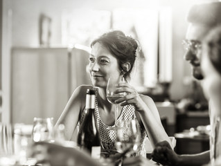 Mixed group of friends having fun while sharing a meal 