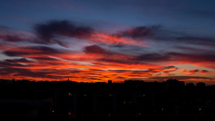 sunset sky with orange clouds on the city. Background wallpaper