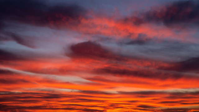 sunset sky with orange clouds on the city. Background wallpaper