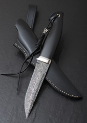 Hunting knife from Damascus mosaic  on a black background. Leather Sheath Handmade