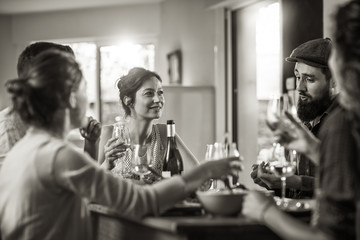 Mixed group of friends having fun while sharing a meal 