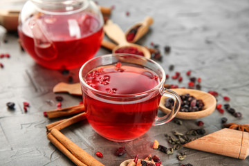 Glass cup of aromatic tea on table