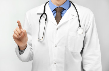 Male doctor showing something on white background