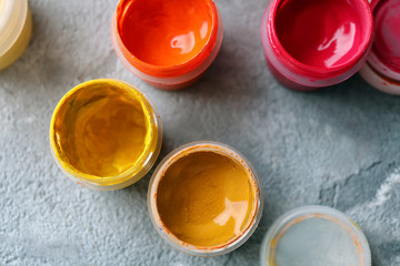 Jars with paints on table, top view