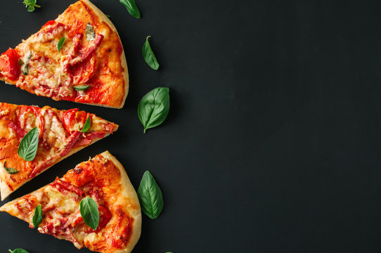 Three slices salami mozarella pizza black background. Top view f