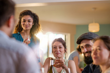 Mixed group of friends having fun while sharing a meal 